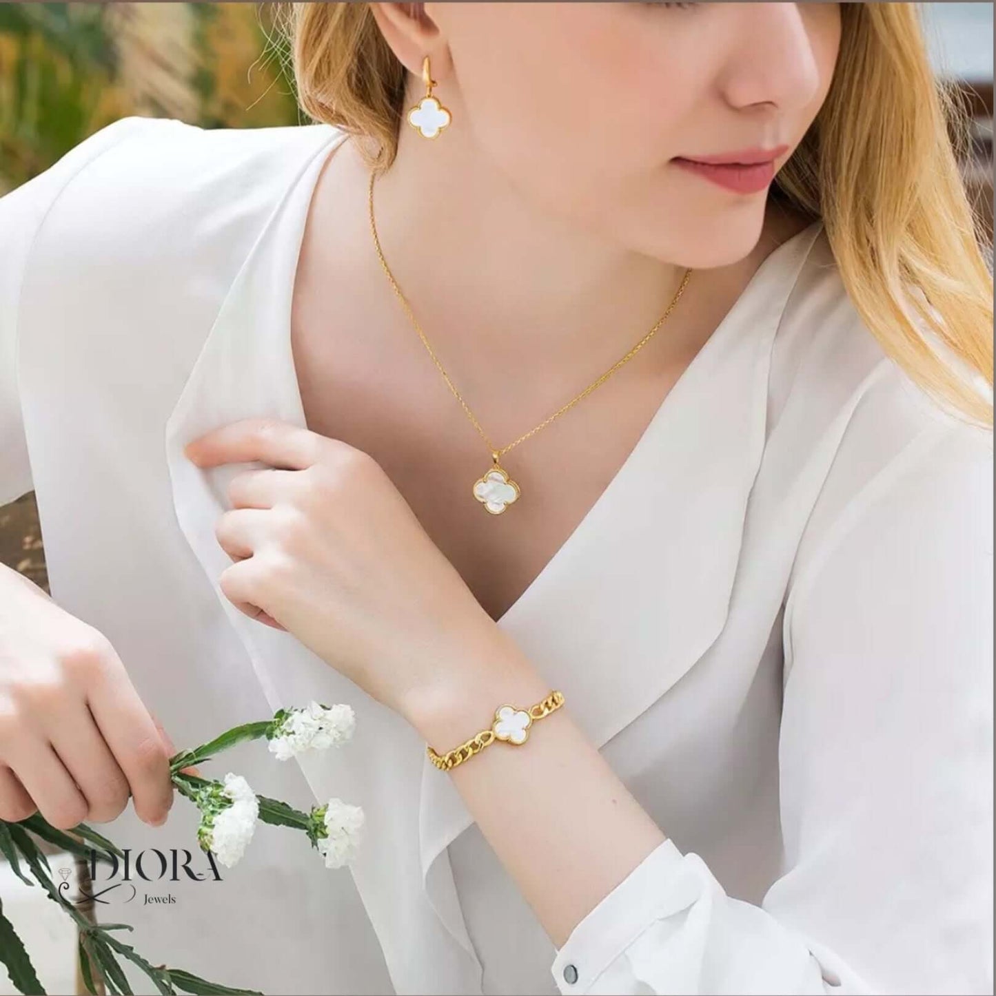Woman wearing gold jewelry with a Diora logo in the corner
