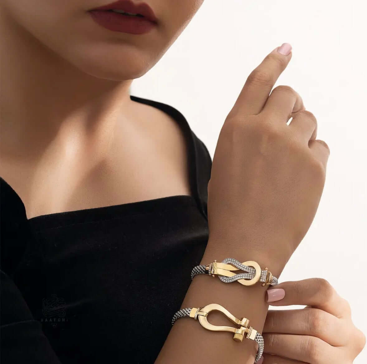 Model wearing two bracelets, showcasing the 18K Infinity Knot Gold Bracelet and its elegant design.