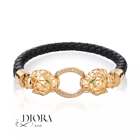 A Diora branded gold bracelet featuring a geometric panther design with diamonds, complemented by a black leather strap.