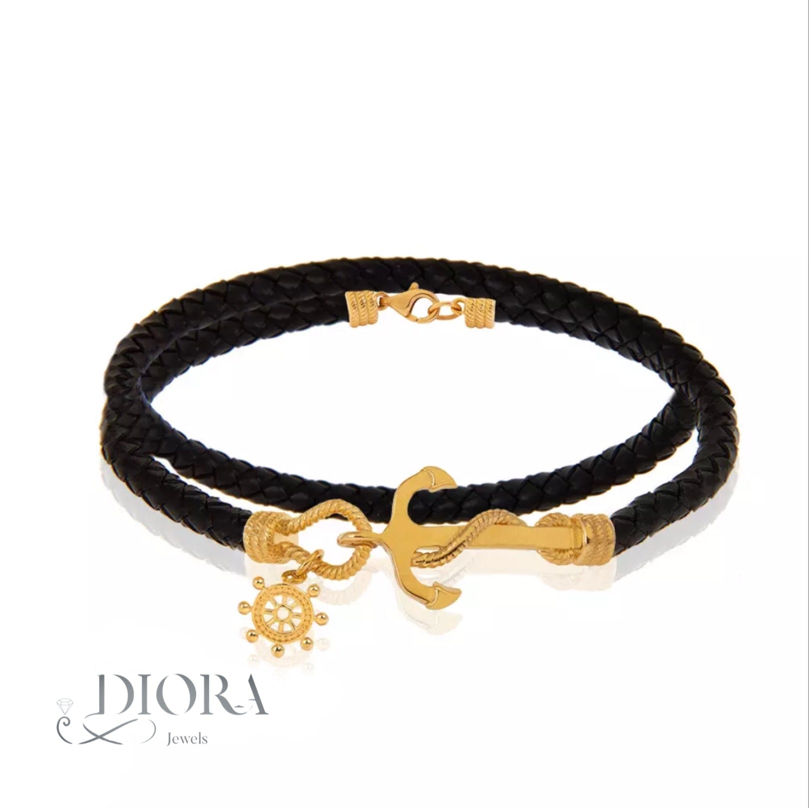 A black leather bracelet with gold plate accents, including an anchor charm.