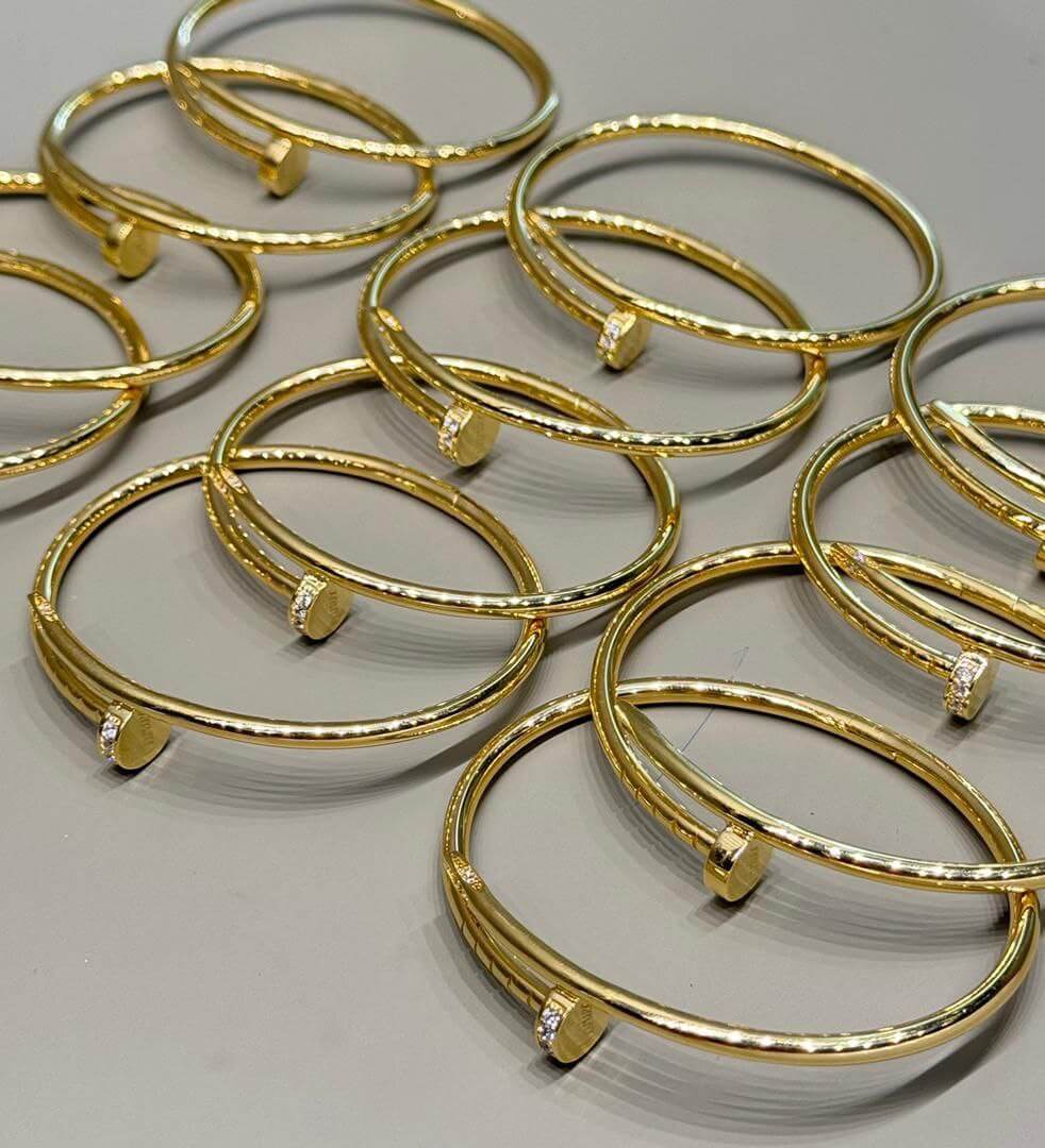 Nail Gold Bracelet - multiple elegant 18K gold bracelets showcasing luxury and style.