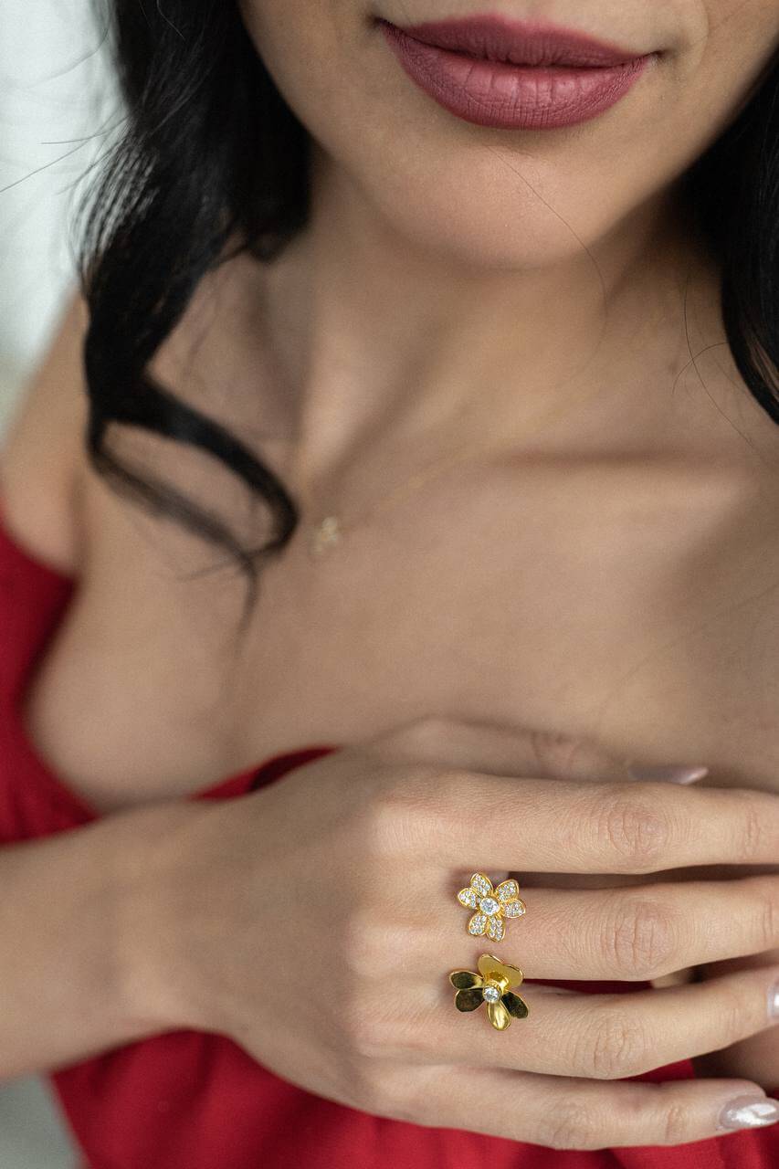 Woman wearing 18k Flowers Ring featuring zirconia stones, showcasing elegance and style.