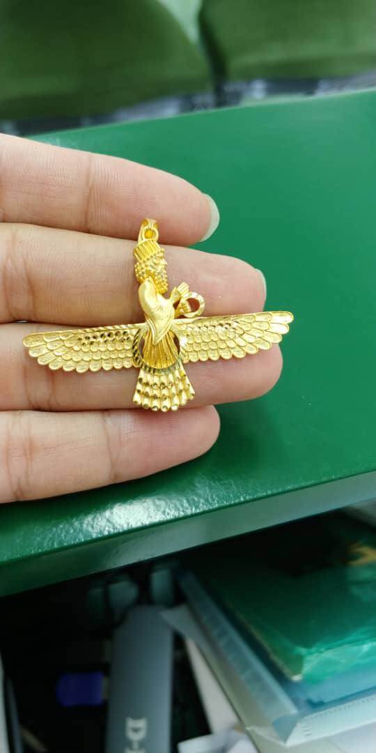 Large Farvahar Gold Pendant displayed in hand with intricate detailing, symbolizing elegance and heritage.