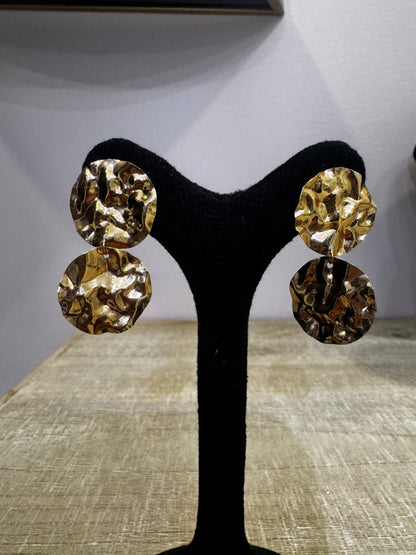 18K Hammered Orbit Gold Hoop Earrings displayed on a jewelry stand, showcasing their unique hammered texture and minimalist design.