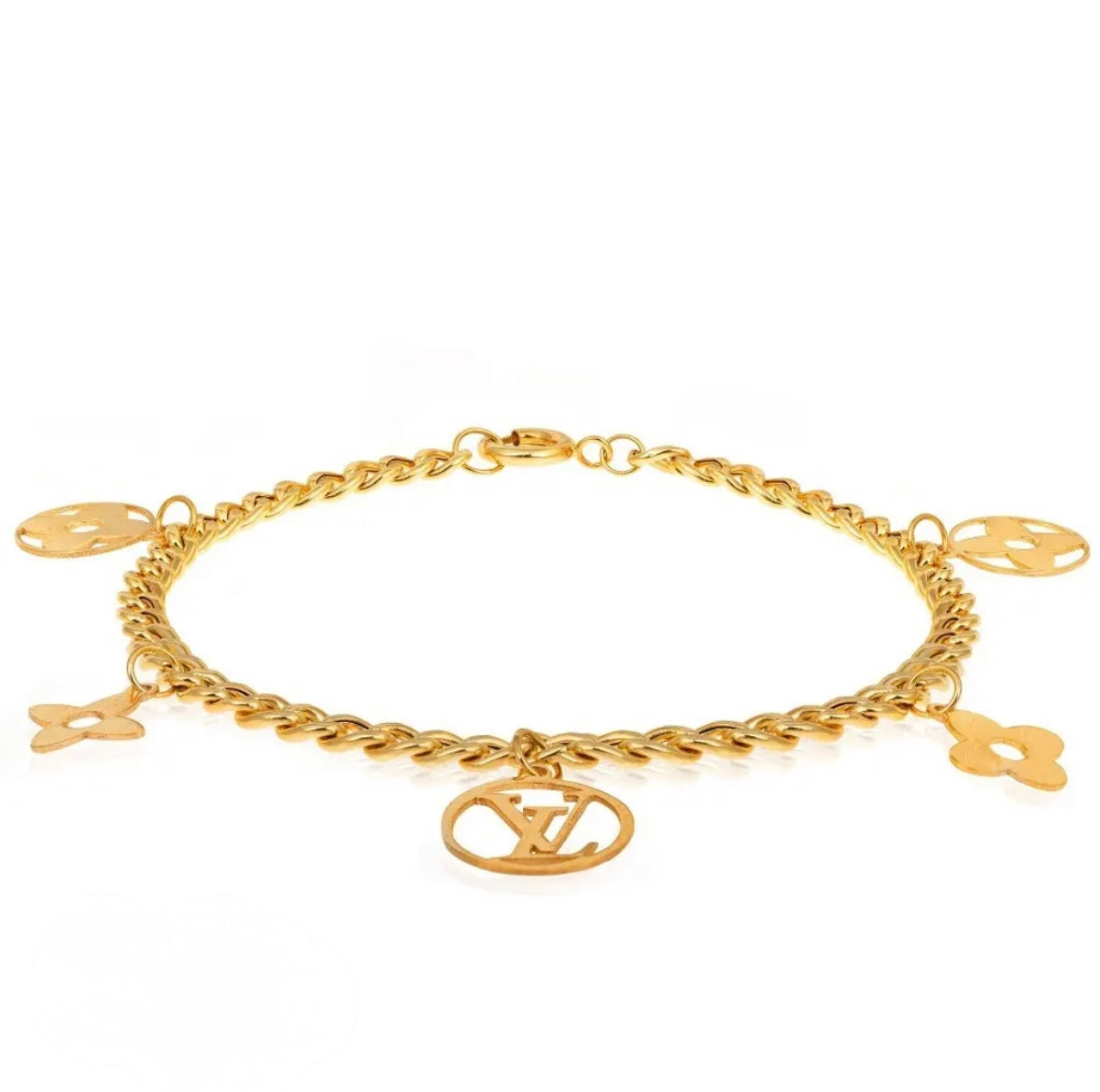 Gold bracelet with charms on a white background